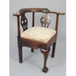 George III oak corner chair, the later carved back rail above pierced splats,