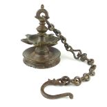 Indian bronze temple oil lamp, of circular form with seven wick wells, suspended from a chain,