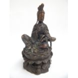 Chinese bronze seated figure of guanyin, holding a ruyi and seated on a lotus pad,