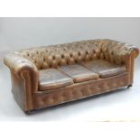 Aged Chesterfield triple seat sofa, green / brown leather, buttonback roll, brass studs,