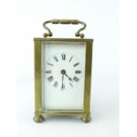 Brass four glass carriage clock, enamel face, Roman numerals, bun feet,