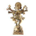 Bronze figure of ganesha, multi armed and standing with a foot raised and a rat to foliate base,