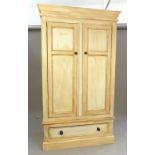 Painted pine wardrobe, the cornice above an arrangement of two panel doors above a drawer,