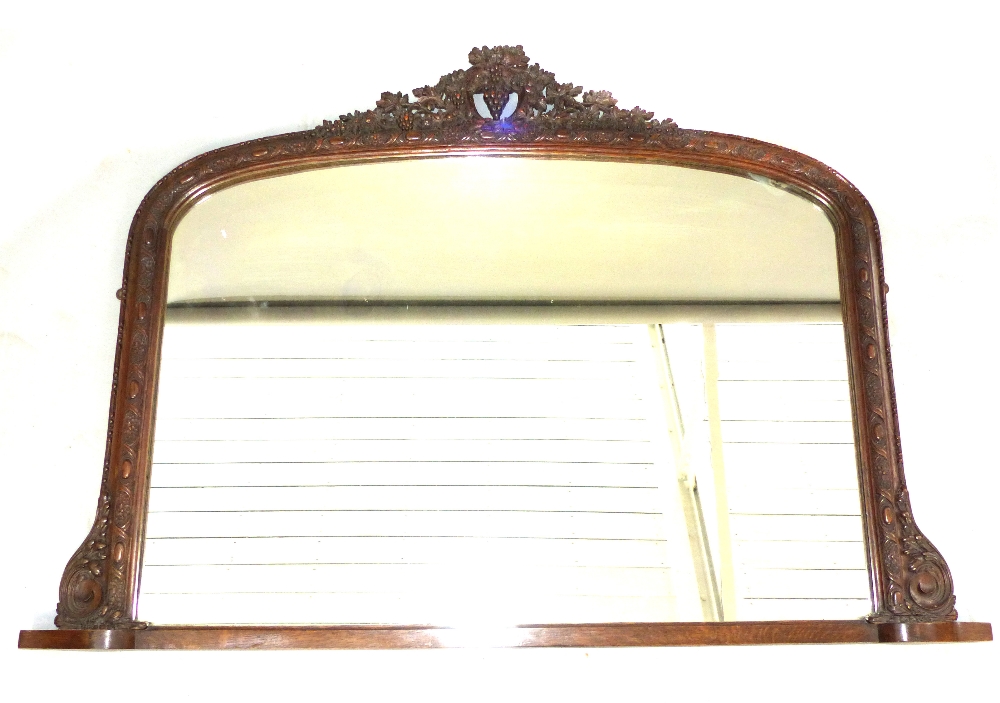 19th century overmantel mirror, the arched plate with a grape and vine surmount,