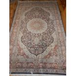 Silk carpet, Qom style with floral design over cream and black ground, 254x 151cm w