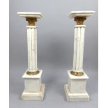 A pair of white marble sculptured stands,