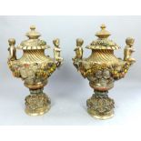 Pair of solid brass lidded urns, accanthus leaves to lid, painted fruit resting cherub handles,