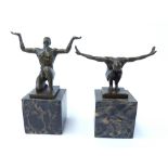 A pair of bronze figures of nude athletes on marble clocks,