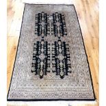 Pakistani rug, geometric design on a black ground, fringed, 224x123cm