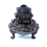 A Chinese bronze three legged lidded censor, the cover depicts a toad-like mythical beast,