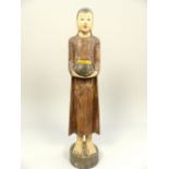 Wooden carving of an Asian woman bringing her offering to the gods,