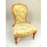 Late 19th C spoonback chair, walnut frame, scroll terminus, bow front seat, turned legs and castors,