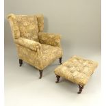 Victorian wingback armchair, roll arms, turned mahogany feet with brass castors,