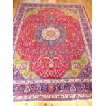 Large Isfahan carpet, central star medallion over traditional floral design and red ground,