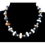 An antique banded agate necklace the graduated,