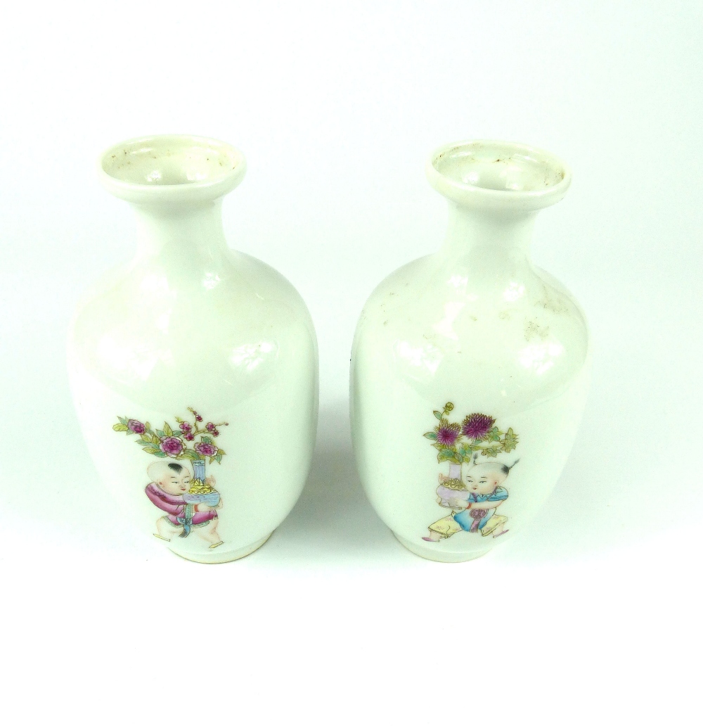 Pair of Chinese bottle vases decorated with children carrying vases and flowers,