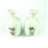 Pair of Chinese bottle vases decorated with children carrying vases and flowers,