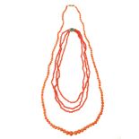 Two Antique coral bead necklaces one formed of three strands held together by a jewelled clasp,