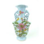 A Chinese blue monoglazed twin handled porcelain vase of shouldered ovoid form,