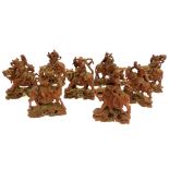 Set of eight carved Chinese studies of the Immortals riding on animals, glass eyes, c 1970,