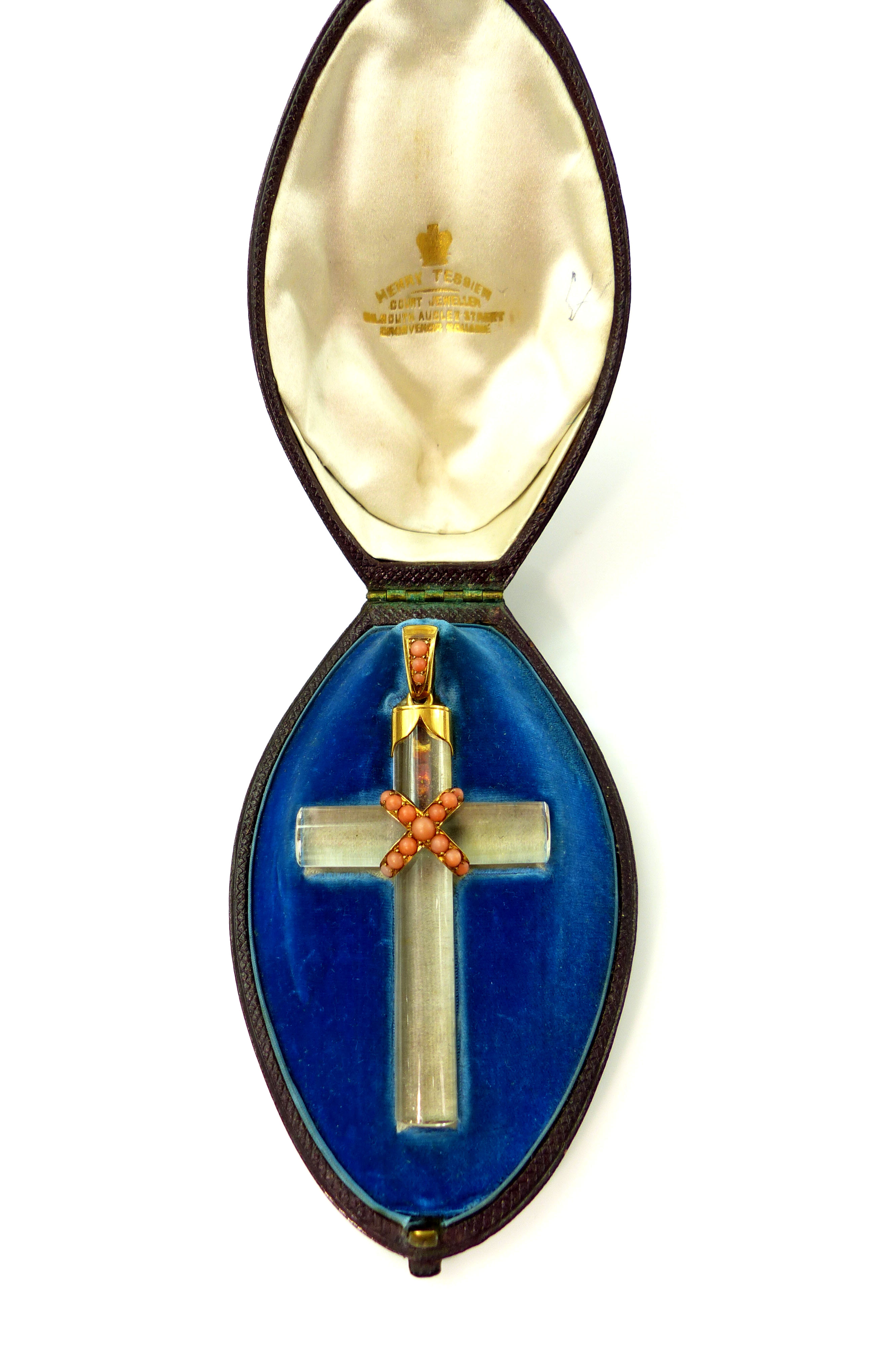 An antique rock crystal and coral cross pendant with high carat yellow gold loop the cross with a