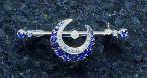 An antique diamond, sapphire and seed pearl crescent moon bar brooch in rose gold,