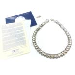 A vintage Sterling Silver chain necklace formed of interlocking rings with a circular stud design to