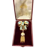 An antique turquoise bow and tassel brooch in yellow gold, the moulded ears,