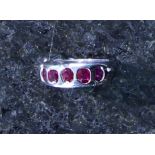 A Burmese ruby five stone ring in white gold, the five graduated oval cut stones,