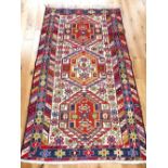 Qashqai kilim rug, geometric design over red and ivory within indigo blue star borders, 204x111cm