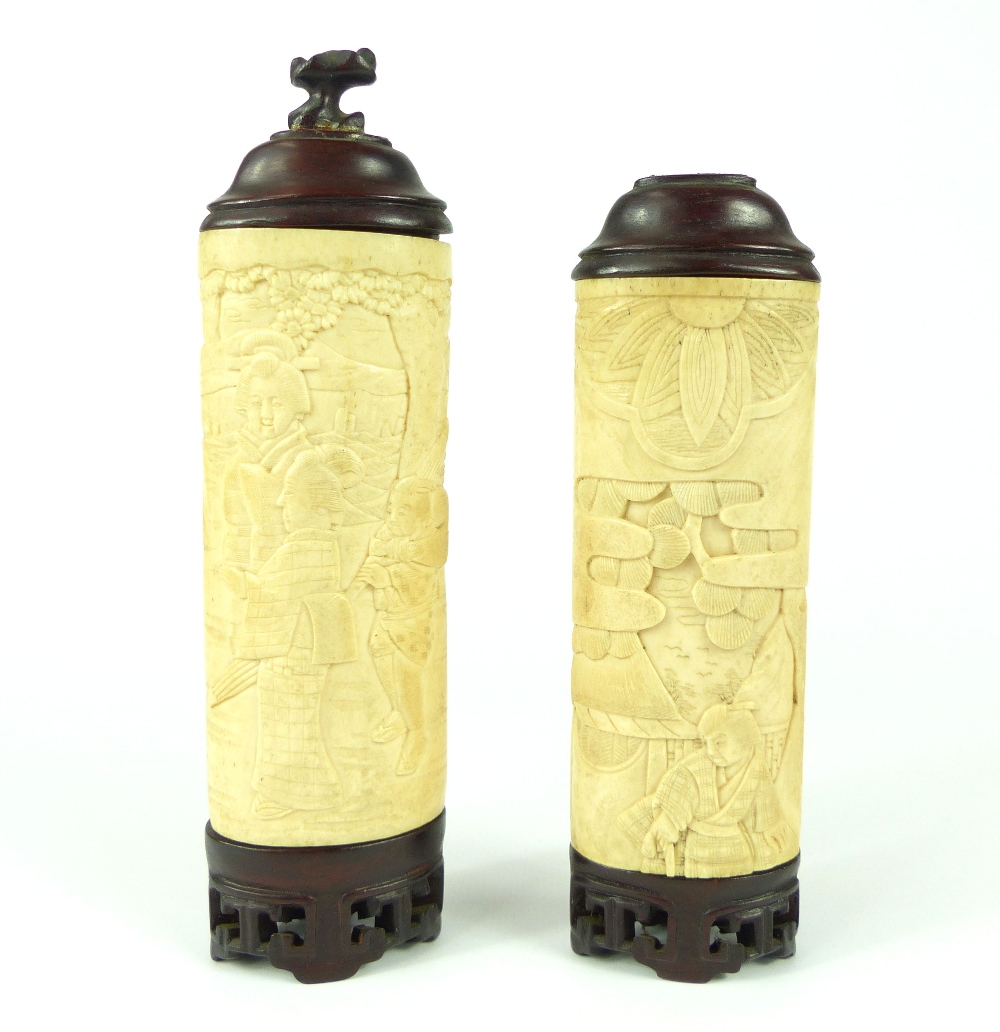 Pair of carved 19th C ivory cylinders, figural and scenic relief carved, with hardwood bases and