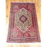 Qashqai rug, geometric design within stepped medallions, floral design to border, 165x104cm