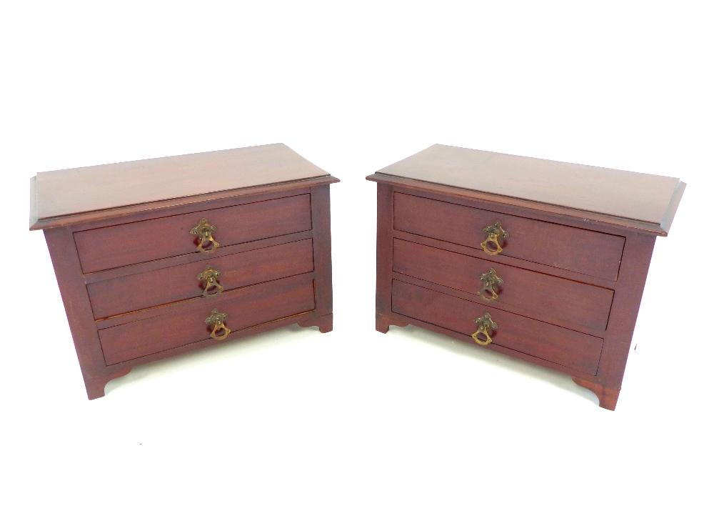 Pair of early 20th C mahogany jewellers' drawers, miniature three drawer chests, bracket feet, 24