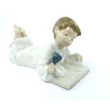 Nao porcelain figurine of a boy reading book, 19cm, together with a large Bretby lustre glazed