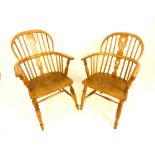 Pair of late 19th century elm comb back elbow chairs, vase splat, turned supports and legs, saddle