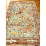 Qum part silk rug, decorated with hunting scene over pale blue ground, within floral and script