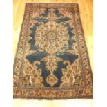 1920s Isfahan rug, floral tear drop medallion to centre over indigo ground, geometric borders,