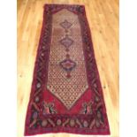 Bokhara design runner, decorated with elephant pad medallions to centre within reticulated