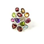 Multi colour gem set ring, on a ribbed band white metal band, 14g