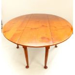 A cherrywood ''hunt'' table with dropleaf, gateleg action on circular section legs with pad feet,