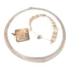 Three items of jewellery comprising: gatelink bracelet, gold Vesta and a necklace.