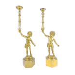 Pair of brass figural candle holders in the form of young boys on hexagonal plinths, 43cm high (2)
