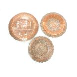 Three Persian copper and silver inlaid dishes, largest 25cm dia (3)