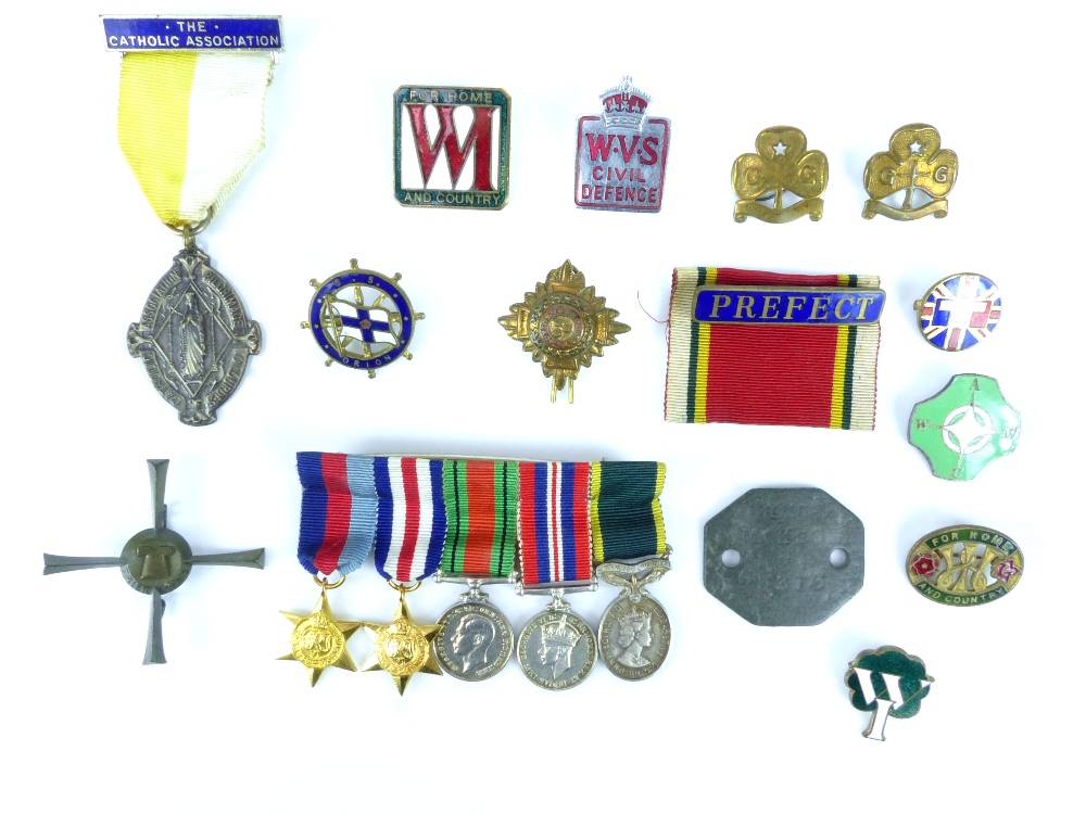 Row of miniature WWII military Medals and ribbons including Territorial, a dog tag, Catholic