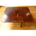 A Georgian Cuban mahogany cottage dining table with dropleaf gateleg action on square section