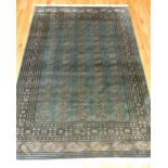 Bokhara design carpet, decorated with five rows of elephant pad medallions to centre over olive