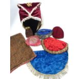 Collection of Persian embroided textiles to include ceremonial hats, quran covers and pouch