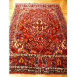 Persian carpet, quatrefoil medallion to centre within tear-drop medallion, overall with floral