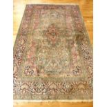 Kashmiri part silk rug, shaped medallion to centre, overall with floral design, over pink and