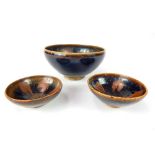 Three Chinese rust brown glazed Tenmoku pottery bowls, 8.5 x 16.2cm dia, 4.8 x 9.8cm dia, 3.